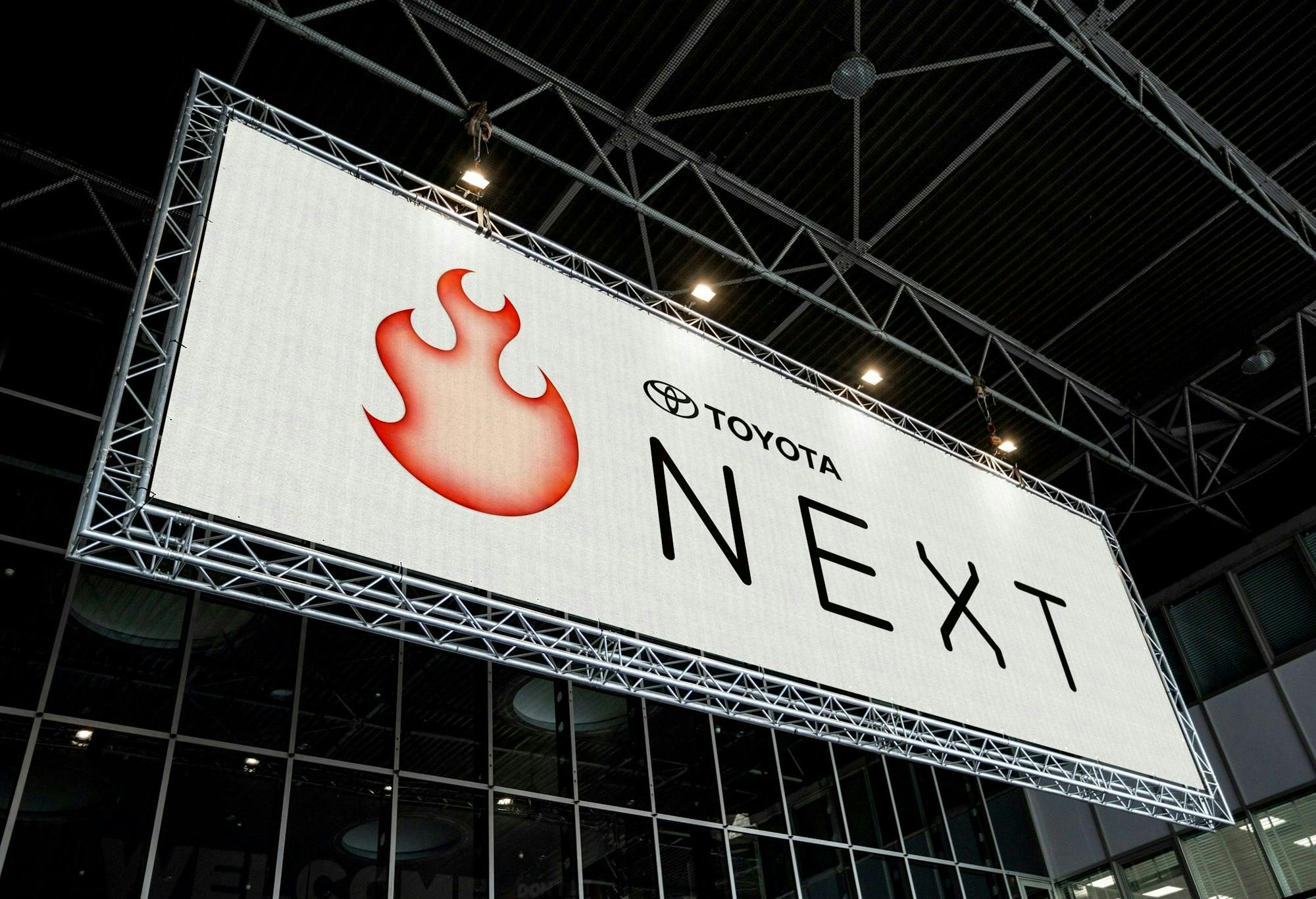 Large outdoor banner containing Toyota Next logo